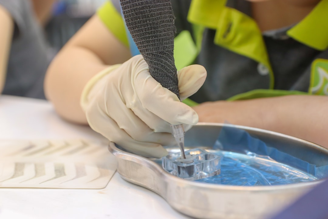 A person in a yellow shirt and white gloves